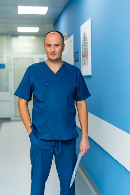 Portrait of mature male doctor standing in hospital corridor Healthcare And Medicine