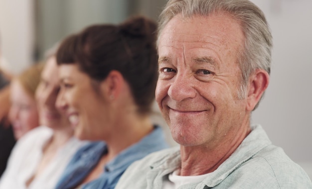 Portrait mature man and family on sofa together for love support and retirement visit on weekend break Male person smile and people on couch in home happy for care support and relationship