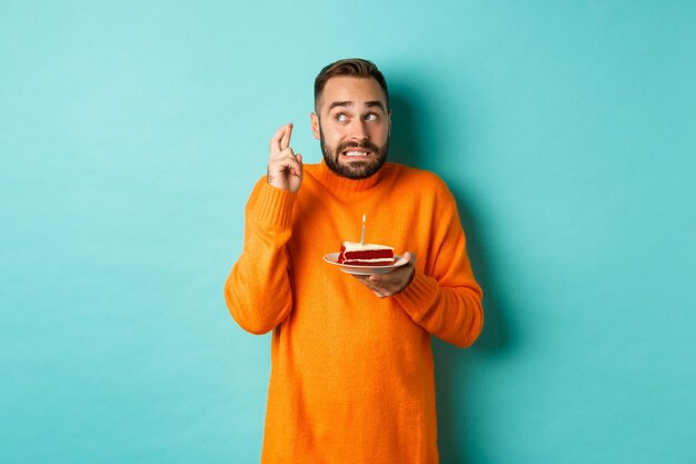 Portrait of mature man standing against blue background