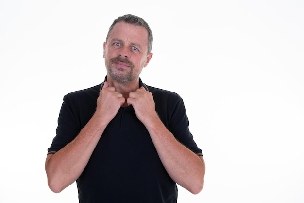 Portrait of mature man standing and posing on background handsome middle aged guy hand on the collar