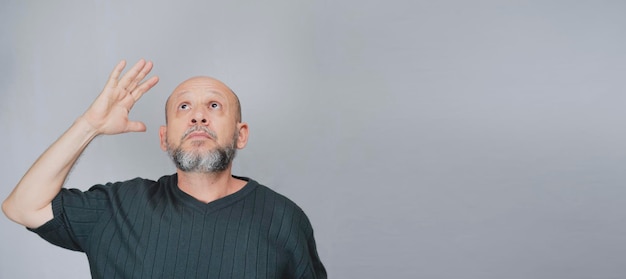 Photo portrait of mature man standing on white background bald bearded man making gestures formal style