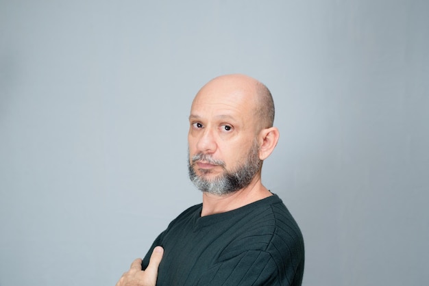 Portrait of mature man standing on white background Serious bearded man Formal style