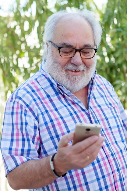 Portrait of mature man using mobile phone