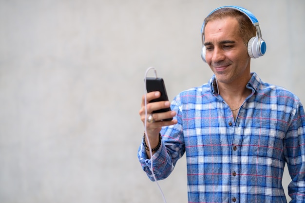 Portrait of mature Persian hipster man outdoors