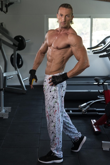 Portrait Of A Mature Physically Fit Tattoo Man Showing His Well Trained Body  Muscular Athletic Bodybuilder Fitness Model Posing After Exercises