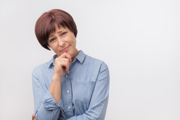 Portrait of mature woman on grey background