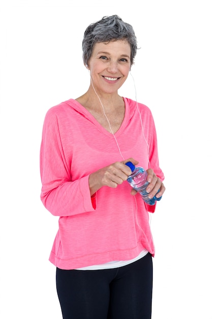 Portrait of mature woman opening water bottle