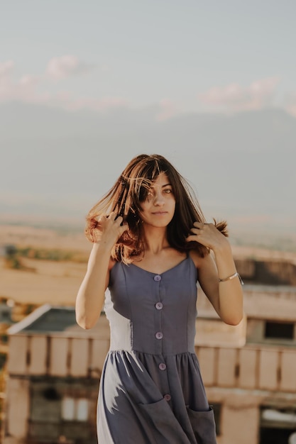 portrait of mature woman standing on terrace during sunset