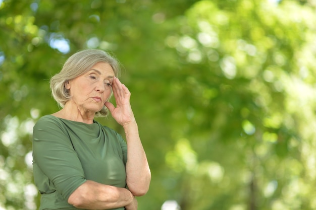 Portrait of a mature woman, upset posing outdoors