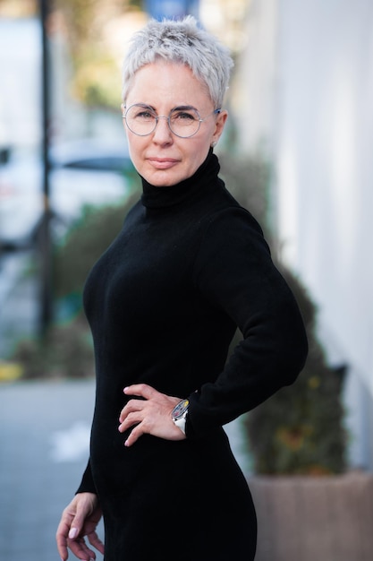 Portrait of a mature woman with grey hair and eyeglasses Casual look