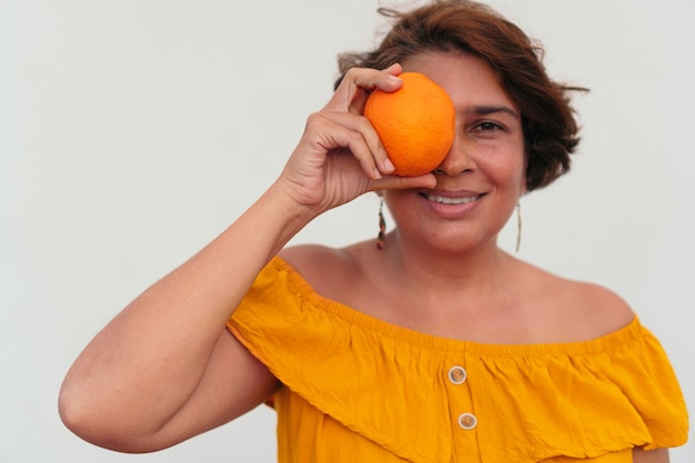 Portrait of a mature woman with an orange