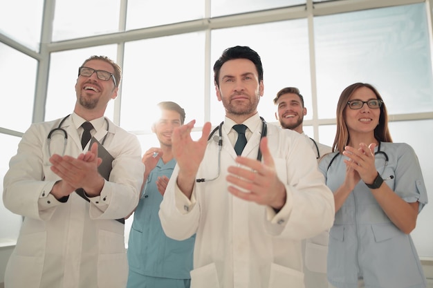 Photo portrait of medical team applauding and smiling in meeting at conference room