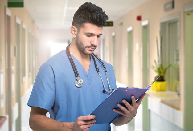 Portrait of a medical worker reading a document on a clipboard