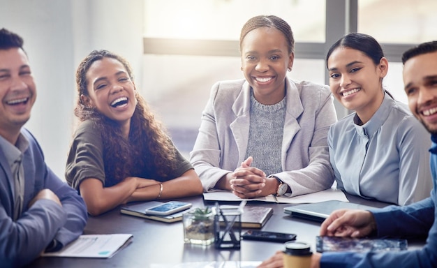 portrait meeting and business people laughing in office for teamwork planning or discussion at table lens flare diversity and group of workers for ideas conversation or collaboration on project