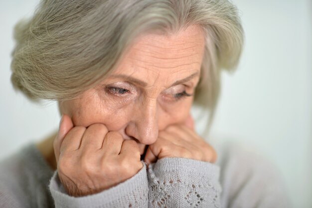 Portrait of a melancholy senior woman close up