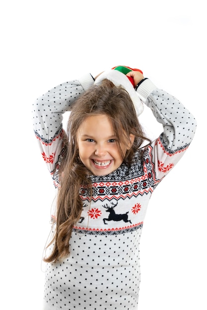 Portrait of merry laughing girl in white knitted christmas sweater with reindeer taking off gnome ch...