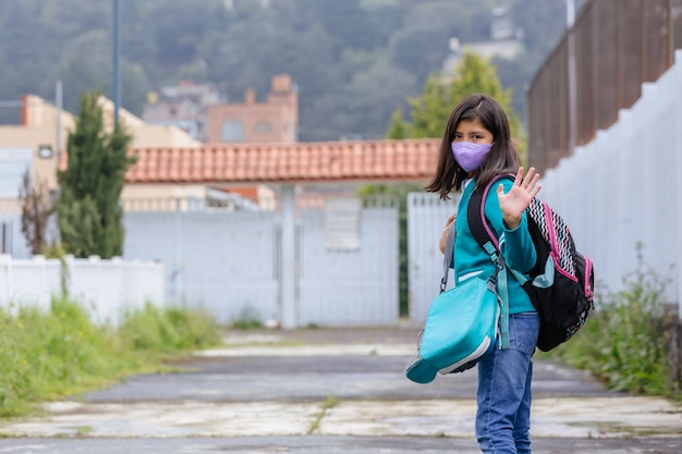 Portrait of a Mexican school girl greeting on first day of back to school