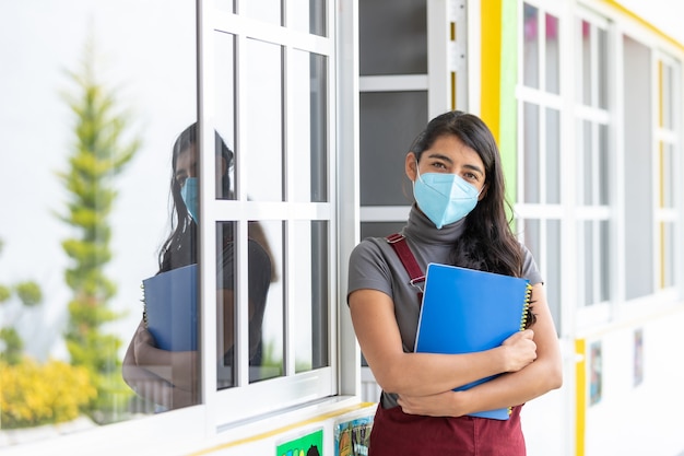 portrait of a mexican teacher wearing face mask after coronavirus pandemic