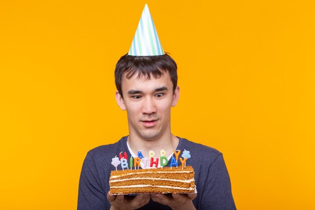 Portrait of mid adult man against cake