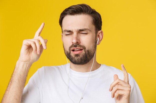 Portrait of mid adult man holding cigarette over yellow background