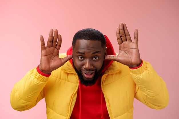 Portrait of mid adult man standing against red background