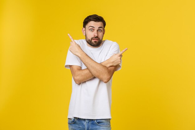 Portrait of mid adult man standing against yellow background