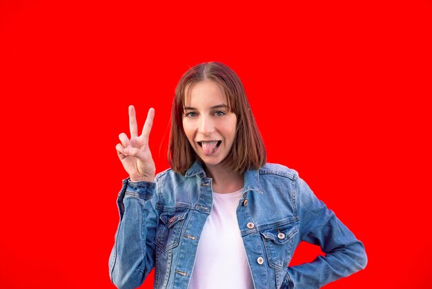 Portrait of mid adult woman against red background