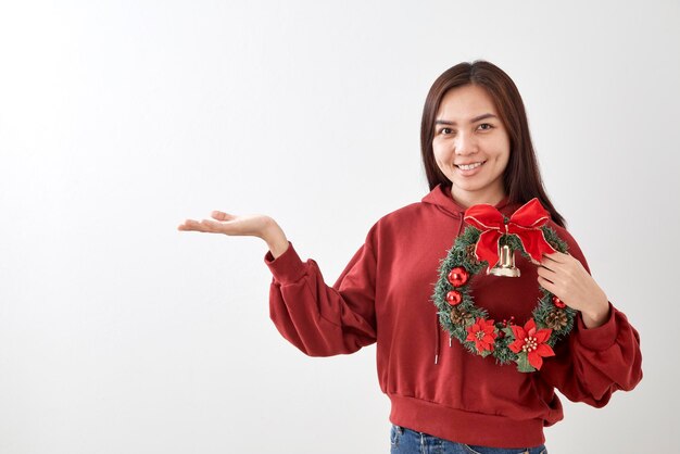 Photo portrait of mid adult woman holding wreath against white background