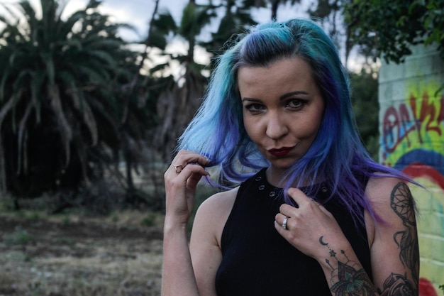 portrait of mid adult woman with dyed hair on land