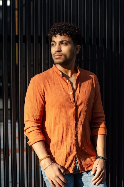 Portrait of a mid east man posing on black fence