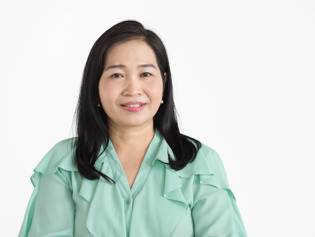 Portrait of middle aged Asian woman wearing mint green blouse looking neat smiling beautifully with confident isolated.