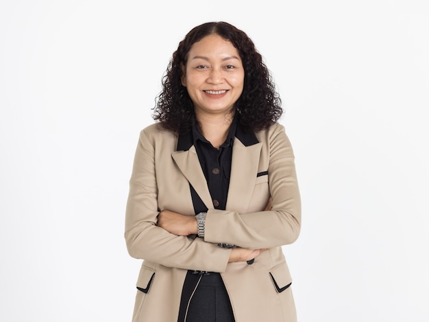 Portrait of middle aged Asian woman with curly black hair wearing black shirt and beige jacket looking neatly smiling with confident isolated.