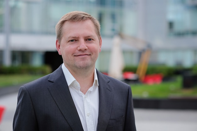 Portrait of middle aged confident businessman at the office, outside