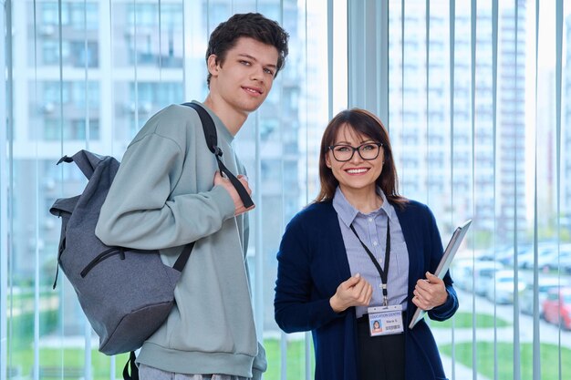 Photo portrait of middle aged female teacher and male college student