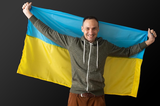 portrait of a middle aged man with flag of ukraine