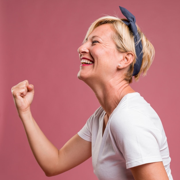 Portrait of middle aged woman in celebration pose