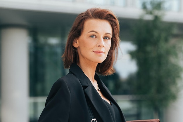 Portrait of a middleaged businesswoman with ginger hair looking away