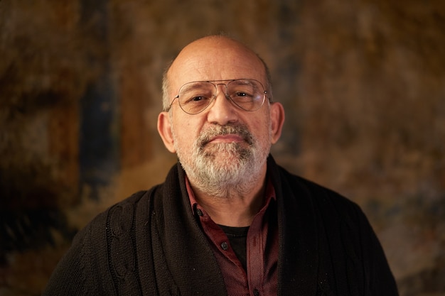 Portrait of a middleaged caucasian man looking at smiling camera look of an older person indoors