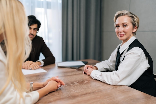 Portrait of middleaged s businesswoman smiling looking at camera posing in boardroom during formal