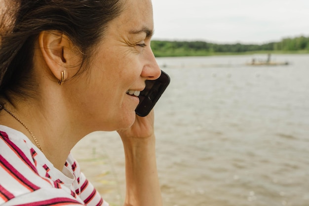 Photo portrait of a middleaged woman talking on a mobile phone