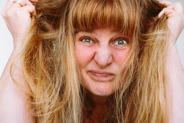 portrait of a middleaged woman with long blond red tangled hair