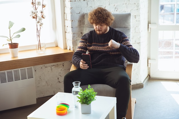 Portrait of millenial boy using retro toys, meeting things from the past