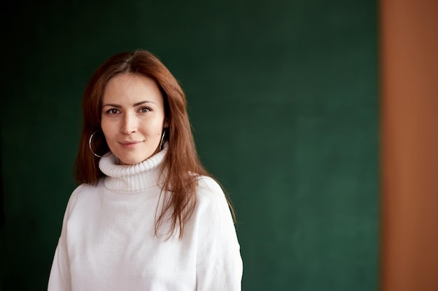 Portrait of millennial female wearing in warm sweater with natural freckles