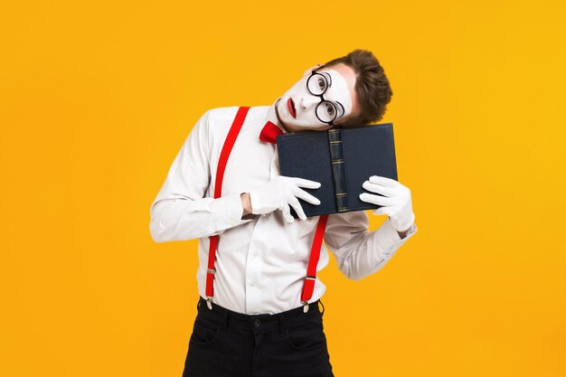 Portrait of mime man artist with book