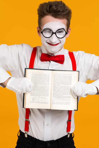 Portrait of mime man artist with book