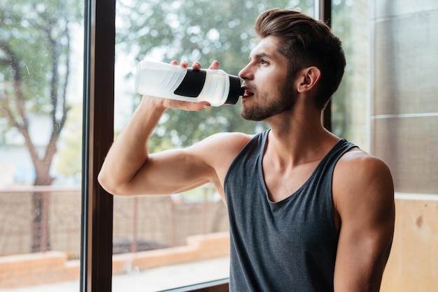 Portrait of model in gym With bottle