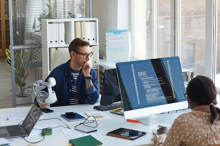 Photo portrait of modern it developers using computers for code programming while working on vr software in office, copy space