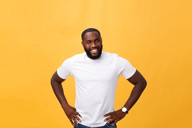 Photo portrait of a modern young black man smiling standing on isolated yellow background.