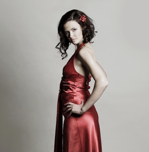 Portrait of a modern young woman in a red evening dress