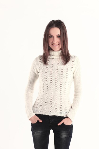 Portrait of modern young woman in white sweater and jeansisolated on white